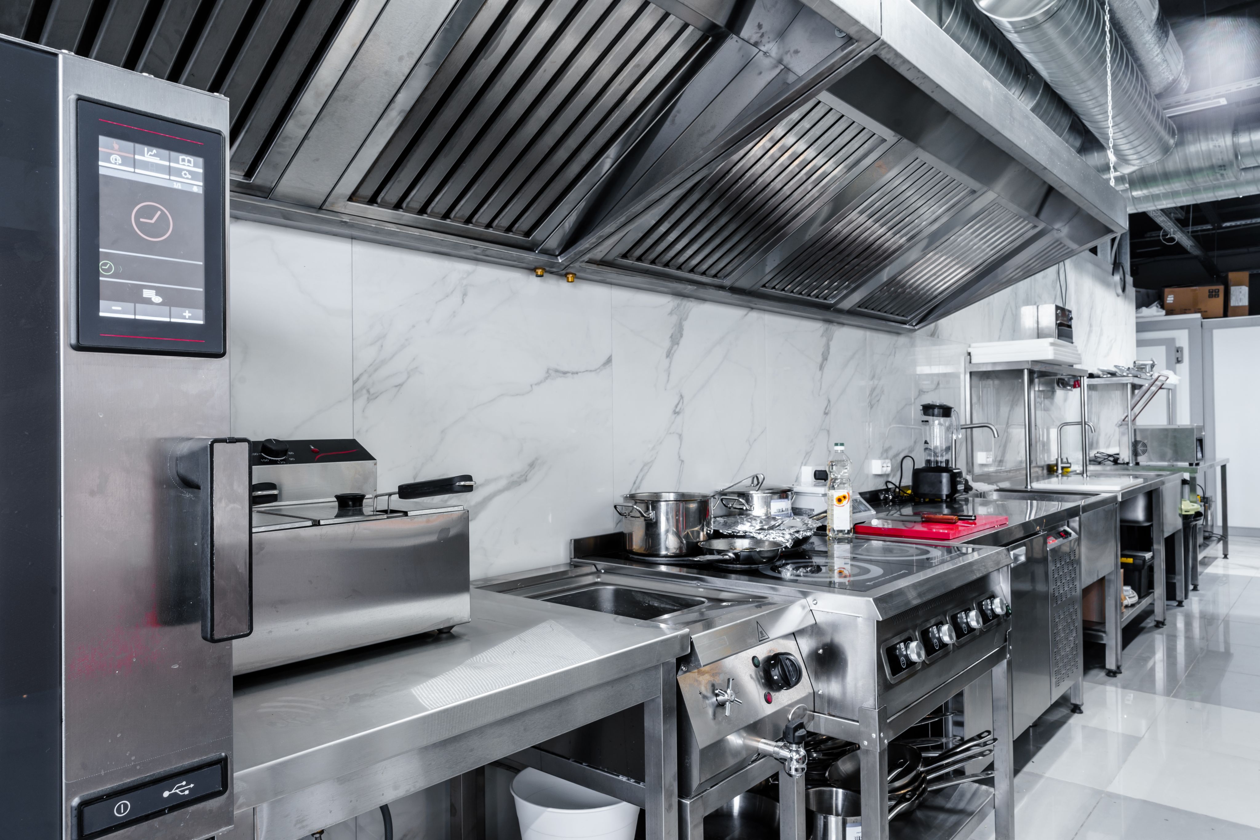 A kitchen equipped with stainless steel appliances and tools.