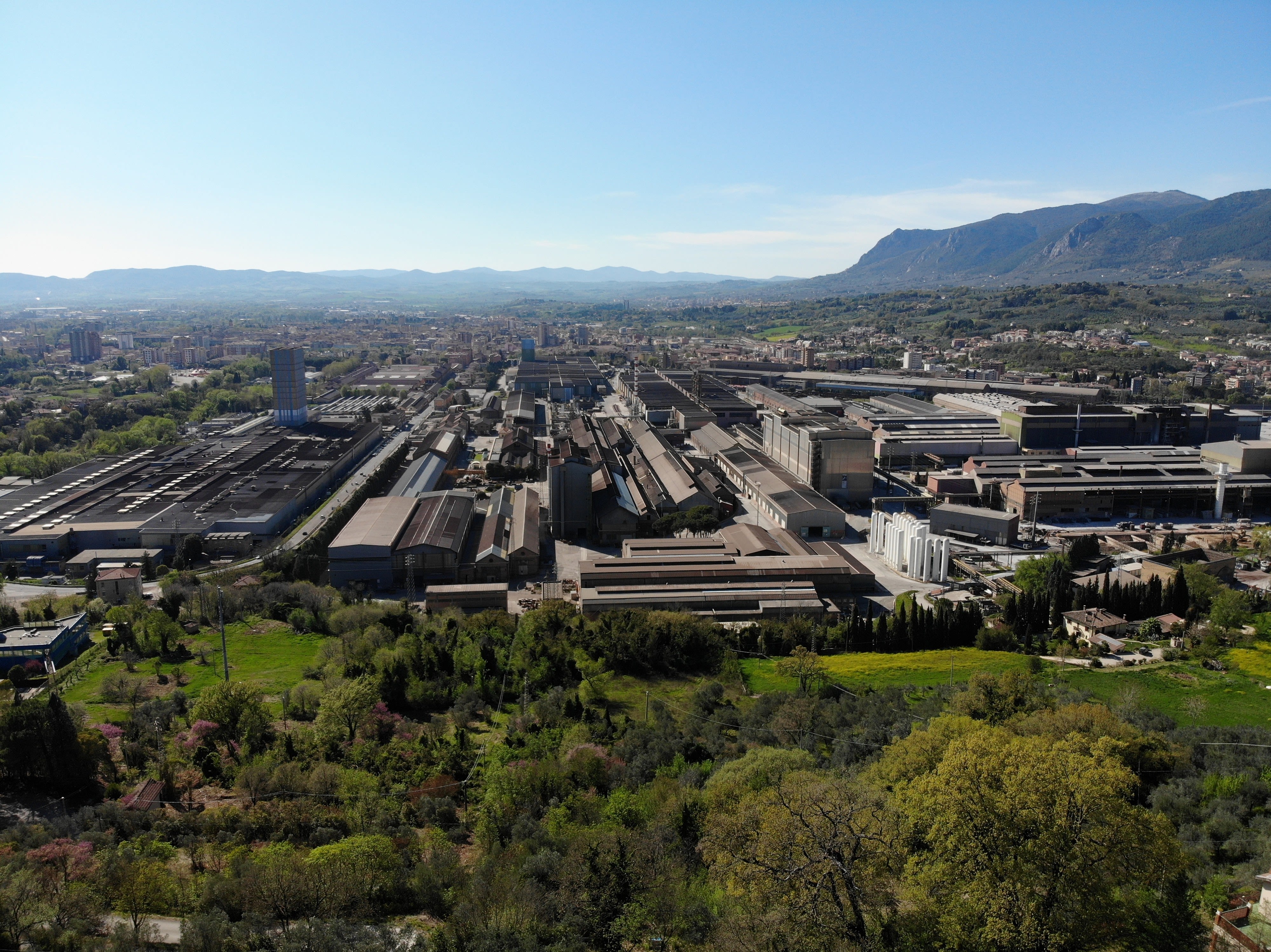 An aerial shot of Acciai Speciali Terni and the surrounding landscape.
